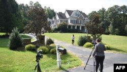 Photographers take photos of the Oleg Smolenkov's house in Stafford, Virginia, Russian media named Smolenkov as the alleged spy the U.S. extracted from Russia in 2017.