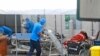  A medical worker wheels an oxygen tank to be used to treat patients at an emergency tent erected to accommodate a surge in COVID-19 cases, at Dr. Sardjito Central Hospital in Yogyakarta, Indonesia, Sunday, July 4, 2021.