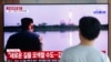 A man watches a TV showing a file image of a North Korea's missile launch during a news program at the Seoul Railway Station in Seoul, South Korea, Tuesday, Aug. 6, 2019.