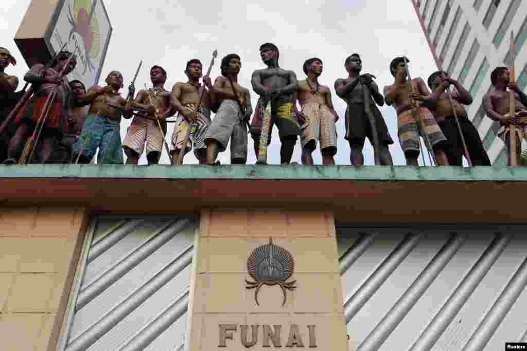 Members of different Amazonian tribes occupy the headquarters of Brazil's Indian Affairs Bureau as they protest a court decision to evict them from a nearby plot of land they have been occupying for several weeks, in Manaus, Sept. 19, 2013.
