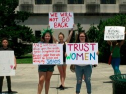 FILE - Abortion rights supporters protest at the Louisiana Capitol, where lawmakers were considering a bill that would ban abortion at as early as six weeks of pregnancy, May 21, 2019, in Baton Rouge, La. The bill won legislative passage May 29.