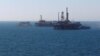 FILE PHOTO: The state flag of Azerbaijan flutters in the wind on an oil platform in the Caspian Sea east of Baku, Azerbaijan, January 22, 2013. REUTERS/David Mdzinarishvili/File Photo - RTS1474L