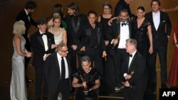 Producers of "Oppenheimer" British film producer Emma Thomas (C), US film producer Charles Roven (L) and British filmmaker Christopher Nolan accept the award for Best Picture onstage during the 96th Annual Academy Awards at the Dolby Theatre in Hollywood,