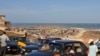 Taxis drivers wait for passengers near an beachfront slum in Accra's Jamestown (VOA/Laura Burke, Sept 2012).
