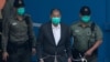 Jimmy Lai, center, who founded the Apple Daily tabloid, is escorted by Correctional Services officers to get on a prison van before appearing in a court, in Hong Kong, Dec. 12, 2020.