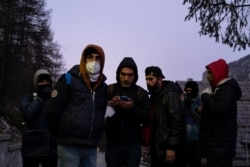 FILE - Kurdish migrants gather to organize their attempt to cross the French border in Claviere, Susa Valley, Alps Region, north-western Italy, Apr. 22, 2021.