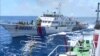 FILE - Screen grab shows Chinese Coast Guard ship 46001 (L) chasing a Vietnamese vessel near the site of a Chinese oil rig in disputed waters in the South China Sea, off Vietnam's central coast. 