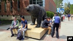 People move about the campus of the University of California, Los Angeles, April 26, 2019. Some students and employees possibly exposed to measles at two Los Angeles universities were still quarantined on campus or told to stay home Friday, but the number was dwindling.