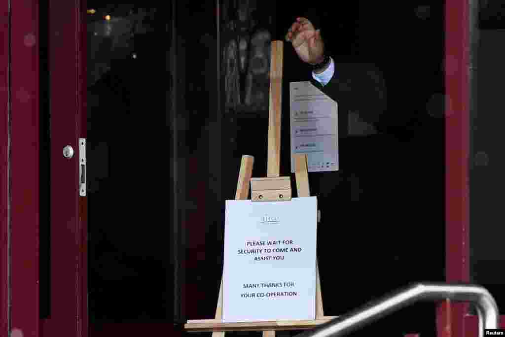 A hotel staff member gestures at the entrance of Crowne Plaza Dublin Airport Hotel, as Ireland introduces a hotel quarantine program for high-risk countries' travelers, in Dublin, Ireland.