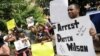 Protestors at the St. Louis County Justice Center call for the arrest of Police Officer Darren Wilson in Clayton, Missouri, Aug. 20, 2014.