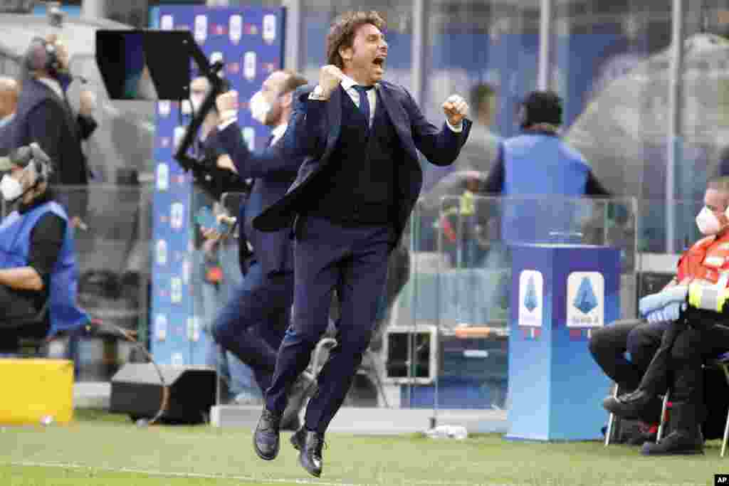 Inter Milan's head coach Antonio Conte celebrates his side's 1-0 win at the end of the Serie A soccer match between Inter Milan and Hellas Verona, at the San Siro stadium in Milan, Italy.