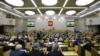 FILE - Duma members listen to Russian Prime Minister Dmitry Medvedev who delivers a speech during a session at the State Duma, the lower house of parliament, in Moscow.