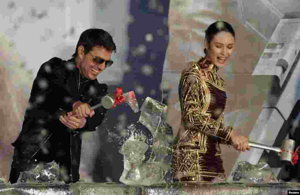Aktor Amerika Tom Cruise dan aktris kelahiran Ukaraina Olga Kurylenko memecahkan pahatan es dalam pertunjukan perdana film terbaru mereka "Oblivion" di Taipei, Taiwan.