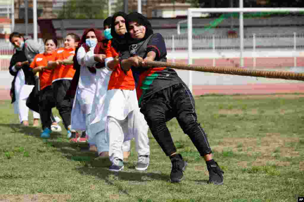 Women participants in a tug of war contest on the International Women's Day celebrations in Peshawar, Pakistan.