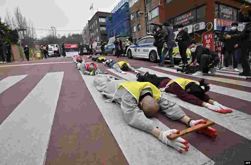 South Korean Buddhist monks and Myanmar nationals living in South Korea march and bow during a protest against Myanmar's military coup in front of the Myanmar embassy in Seoul.