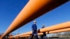 FILE - Engineers oversee the gas distribution system in Kiskundorozsma, 170 kilometers south of Budapest, through which Hungary's FGSZ Gas distribution company routes Russian gas toward Serbia, Jan. 15, 2015.