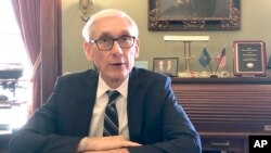FILE - Wisconsin Gov. Tony Evers sits for an interview with The Associated Press at his office in Madison, Dec. 19, 2019.