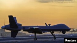 FILE - A MQ-9 Reaper drone taxis at Kandahar Airfield, Afghanistan in this Dec. 27, 2009 photo. The U.S. State Department has approved a request from Italy to arm its two MQ-9 Reaper drones with Hellfire missiles, laser-guided bombs and other other munitions.