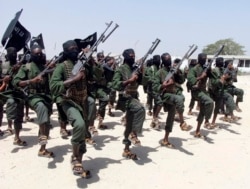 FILE - Al-Shabab fighters march during military exercises in the Lafofe area, some 18 kilometers (11 miles) south of Mogadishu, Somalia, Feb. 17, 2011.