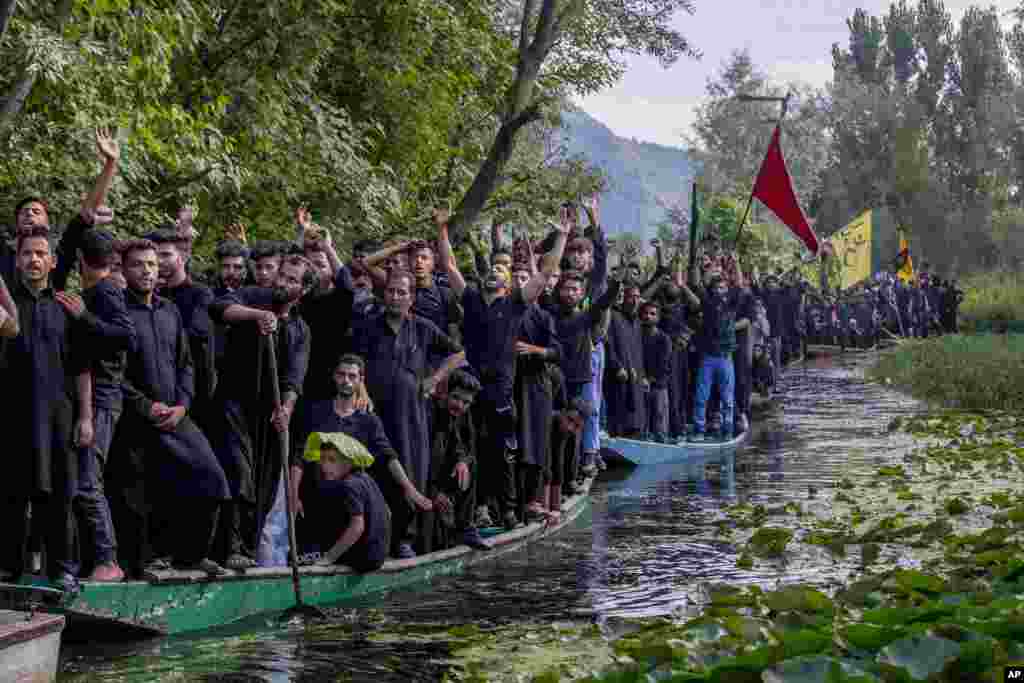 Kashmiri Shi'ite Muslims participate in a Muharram procession on wooden boats in the Dal lake, outskirts of Srinagar, Indian-controlled Kashmir.