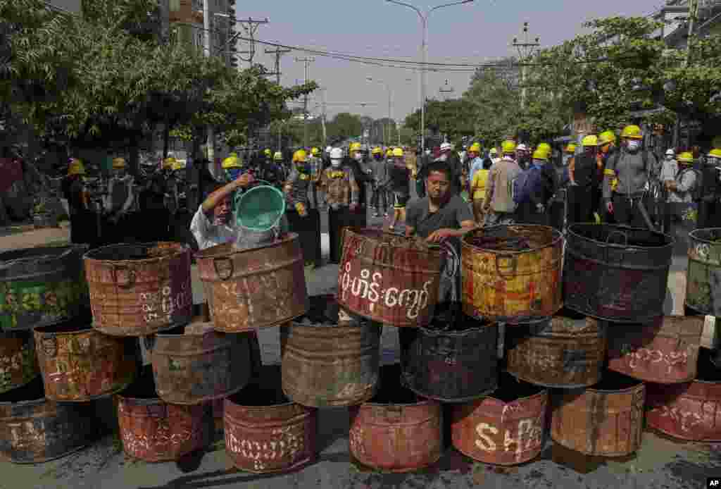 People build barricades to block police in Mandalay, Myanmar. Demonstrators protesting last month's military coup returned to the streets undaunted by the killing of at least 38 people the previous day by security forces.