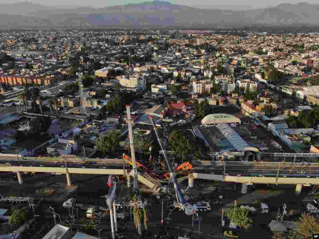 An aerial view of subway cars dangle at an angle from a collapsed elevated section of the metro, in Mexico City, killing at least 23 people and injuring at least 79.