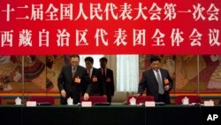 Champa Phuntsok, chairman of the Tibetan Autonomous Region’s people’s congress standing committee, left, and Tibet's governor Padma Choling, right, at a National People's Congress Tibetan delegate group's discussion session in Beijing.