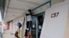 Workers install storm shutters before the arrival of Hurricane Dorian in Marsh Harbour, on the Great Abaco Island, Bahamas, Aug. 31, 2019. 