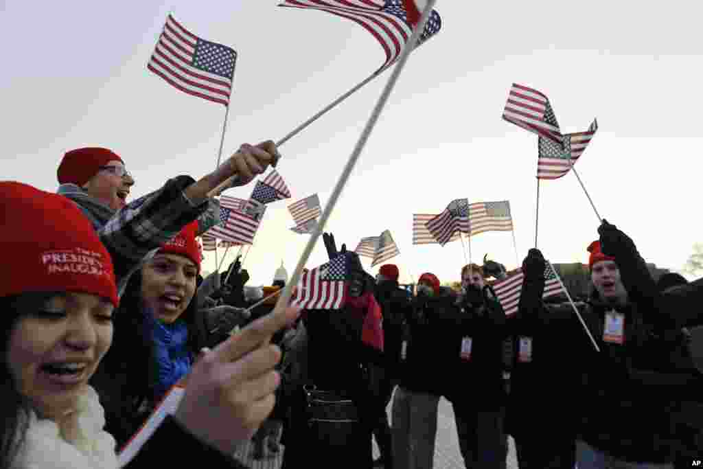 Spectators wave American flags on the National Mall in Washington, Jan. 21, 2013, before the start of President Barack Obama's ceremonial swearing-in ceremony during the 57th Presidential Inauguration.