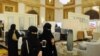 FILE - Saudi women wear the mandatory abaya, or loose-fitting gown, over their clothes in Jeddah, Saudi Arabia, Nov. 8, 2017. Rumors are circulating that a mixed-gender nightclub that does not require women to wear loose robes has opened in the city.