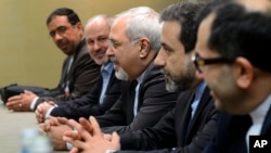 Iranian Foreign Minister Mohammad Javad Zarif, center, attends talks on Iran's nuclear program in Geneva on Nov. 22, 2013. 