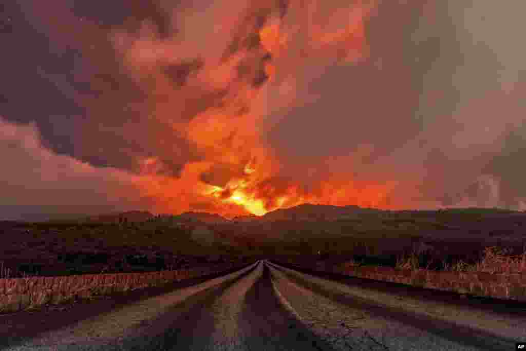 A glowing river of lava gushes from the slopes of Mt Etna, Europe's largest active volcano, near Zafferana Etnea, Sicily, Italy.