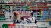 FILE - Women shop at a supermarket in Buenos Aires, Argentina, Oct. 18, 2021. 